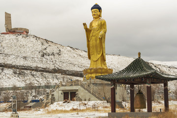  Golden statue of young Buddha near the hill Zaisan in Ulaanbaator