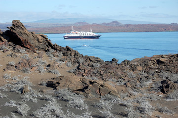 Volcanic landscape with cruise ship anchored in Sullivan Bay, Galapagos