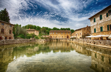 Old thermal baths in the medieval village Bagno Vignoni, Tuscany, Italy/  Spa basin in the antique italian town / Italy, Tuscany, Europe