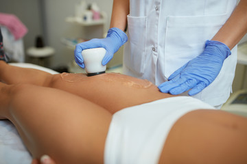 young woman getting anti-cellulite spa treatment