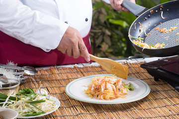 Chef putting Pad Thai to the plate