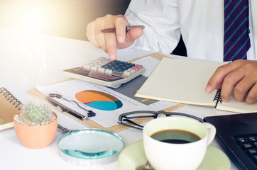 Businessman is working on a table with a functional device is placed.