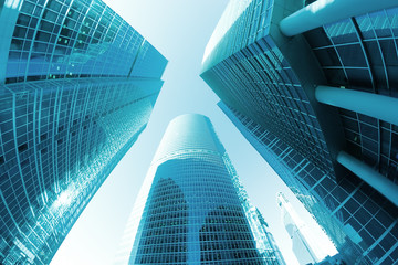 Fototapeta na wymiar Perspective of three office skyscrapers in blue color