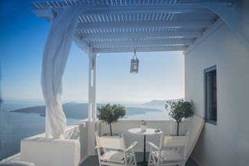beautiful view of the sea through the white curtains on the street in Greece, Santorini