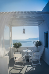 beautiful view of the sea through the white curtains on the street in Greece, Santorini