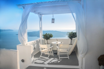 beautiful view of the sea through the white curtains on the street in Greece, Santorini