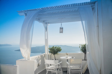beautiful view of the sea through the white curtains on the street in Greece, Santorini