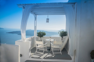 Fototapeta na wymiar beautiful view of the sea through the white curtains on the street in Greece, Santorini