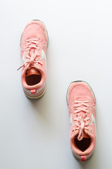 Pink sneakers on a white background, ready for jogging.
