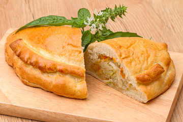 Pie with cabbage and a sprig of basil