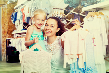 Fototapeta premium Woman with small child in kids apparel boutique