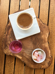 Turkish coffee with Turkish honey served on a wooden tray view from above upright format