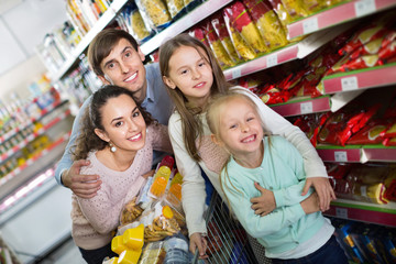 Pleasant  customers with children buying food in hypermarket