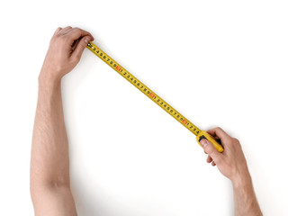 Close-up view of man's hands measuring something with tape-measure isolated on white background