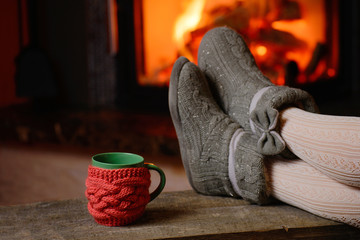 girl in slippers, cup,  on vintage wood near fireplace