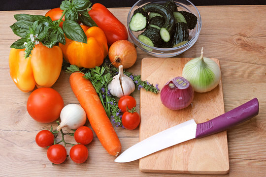 Ceramic kitchen knife and vegetables for salad