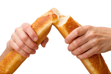 Hands breaking a baguette