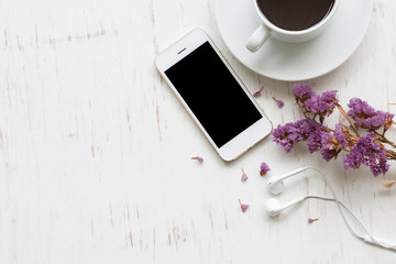 Black coffee with smartphone on white rustic wooden background