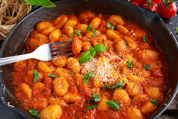 Homemade Italian Gnocchi with marinara sauce, cheese in iron pan