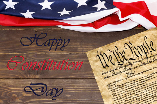 Happy Constitution day USA, flag  USA ,declaration Of Independence Text We The People on wooden background.