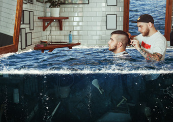 Young man in flooded barbershop