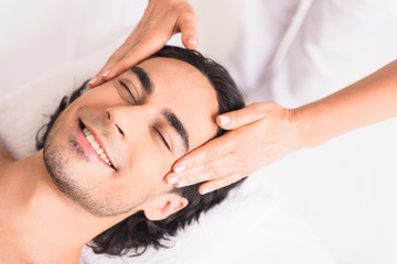 Fototapeta na wymiar Skillful masseuse doing facial massage