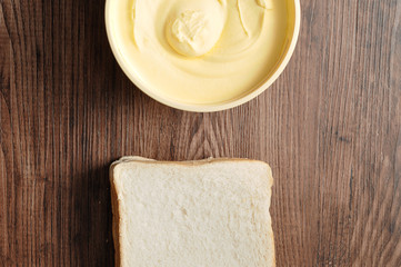 Butter and bread isolated on a wooden background
