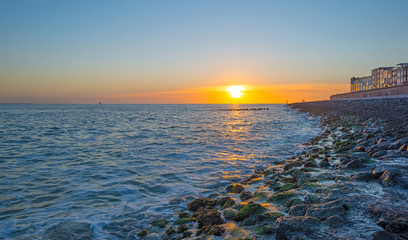 Obraz premium Sunset over a stormy sea in summer