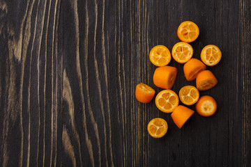 kumquat on a black wooden background

