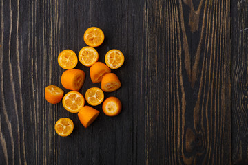 kumquat on a black wooden background
