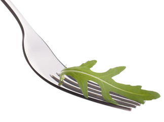 Fresh rucola  salad on fork isolated on white background cutout.