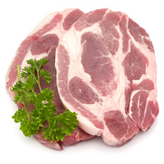 Raw pork neck chop meat with parsley herb leaves garnish isolate