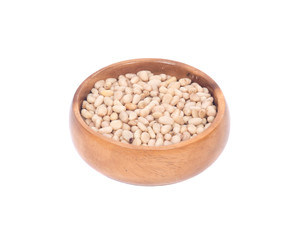Organic pine nuts in wooden bowl separated on white background