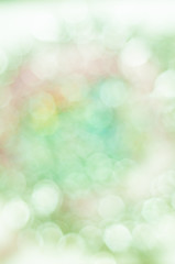 Blurred pale green background with bokeh lights