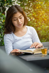 Asian women reading book in the garden