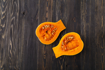 pumpkin slices on a black wooden background
