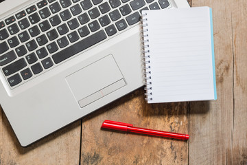 Laptop and with financial documents on wooden table