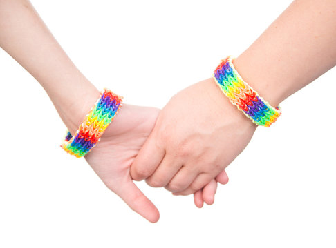 Closeup hands with a bracelet patterned as the rainbow flag. iso