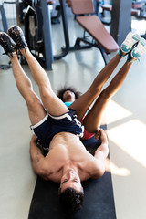 Athletic man and  afro american woman exercise in gym