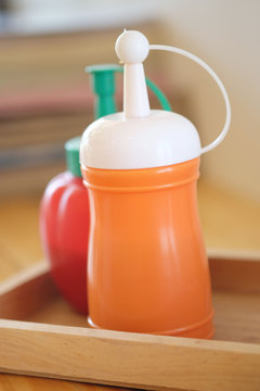 Sauce bottle in orange light in kitchen