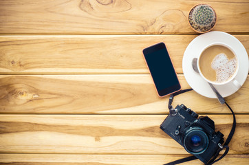 coffee cup, camera, smart phone on wood