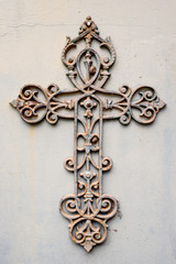 Metal cross against a wall