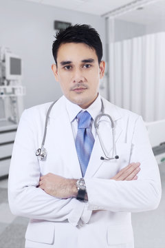 Male doctor standing in clinic room