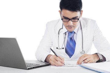 Professional doctor writing prescription