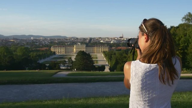 Woman photographing european historical buildings