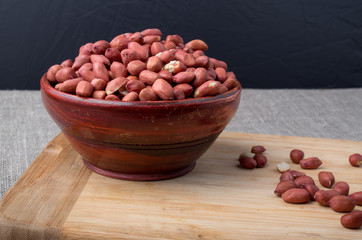 Wooden cup filled with raw nuts peanut