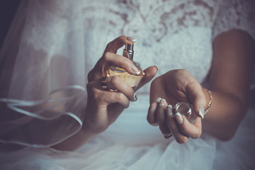 bride applying perfume on her wrist