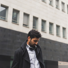 Handsome Indian man posing in an urban context