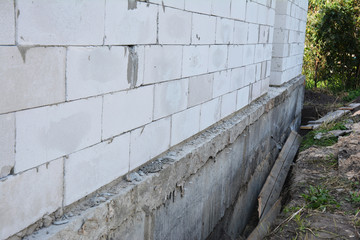 House wall ready for waterproofing foundation with insulation. Insulating Exterior Foundation Walls.