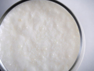 Fototapeta na wymiar Foreground of yogurt on white background